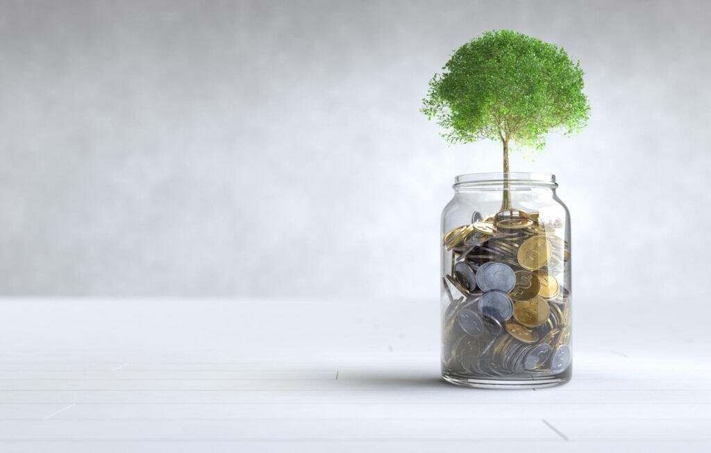 Growing tree in a jar of coins. Financial growth concept.