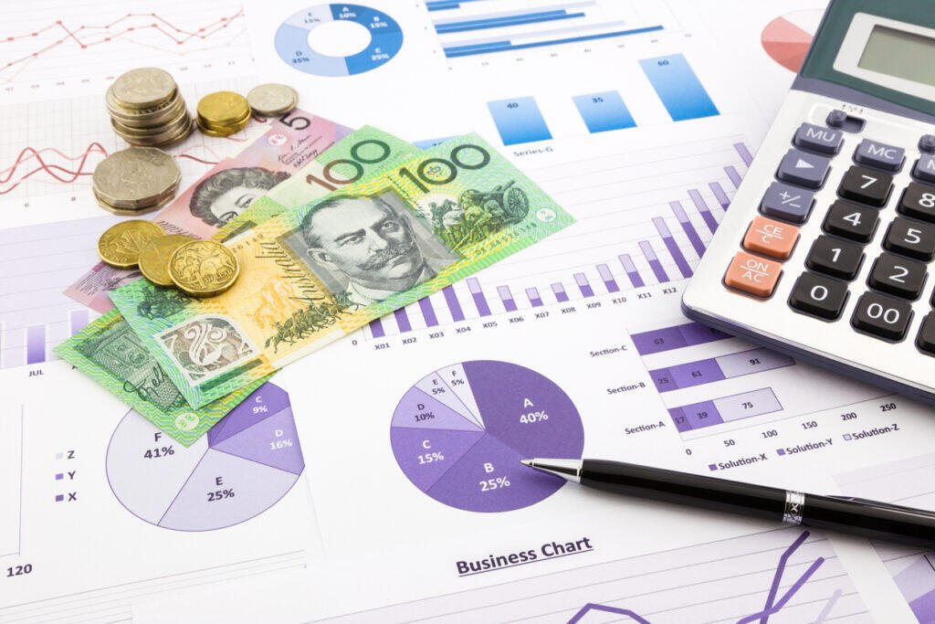 Australian dollar bills, coins, calculator, and financial charts illustrating cashflow and debt management in Adelaide.