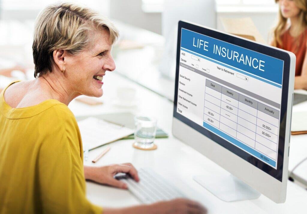 Senior woman reviewing Australian life insurance options online.