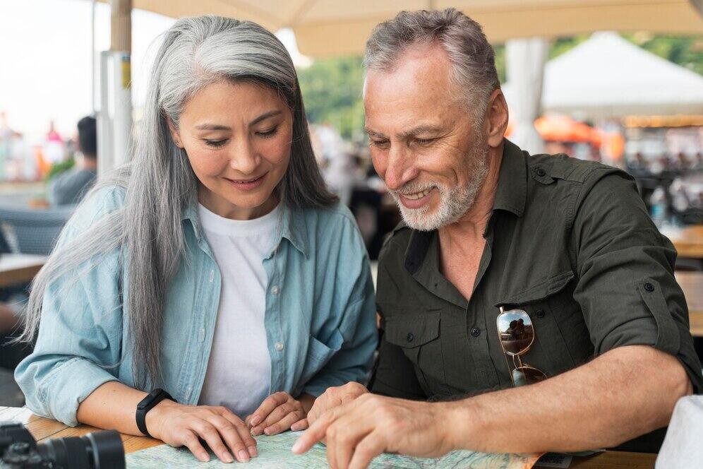 Senior Australian couple reviewing a map, planning retirement.